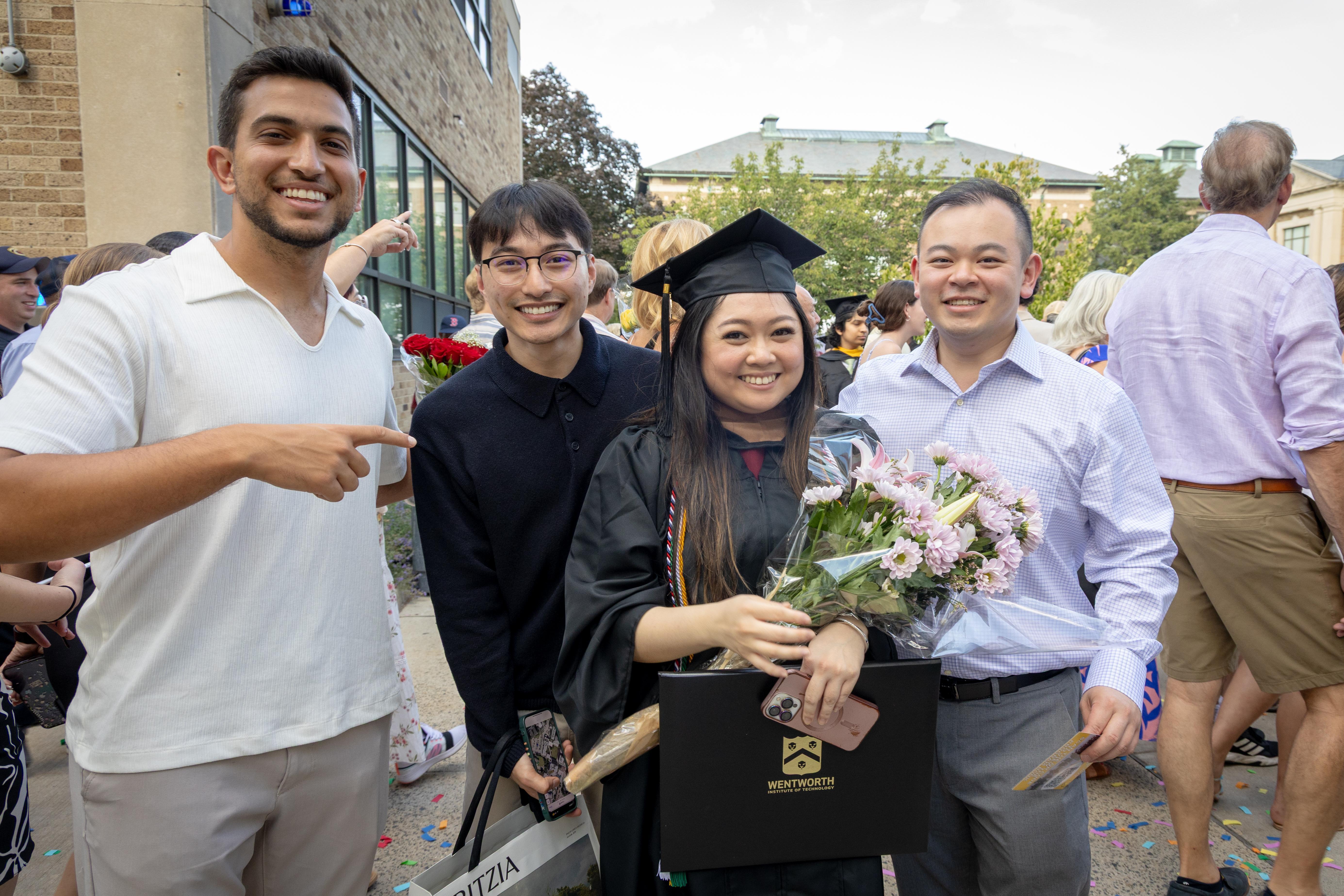 student and family posing after graduation