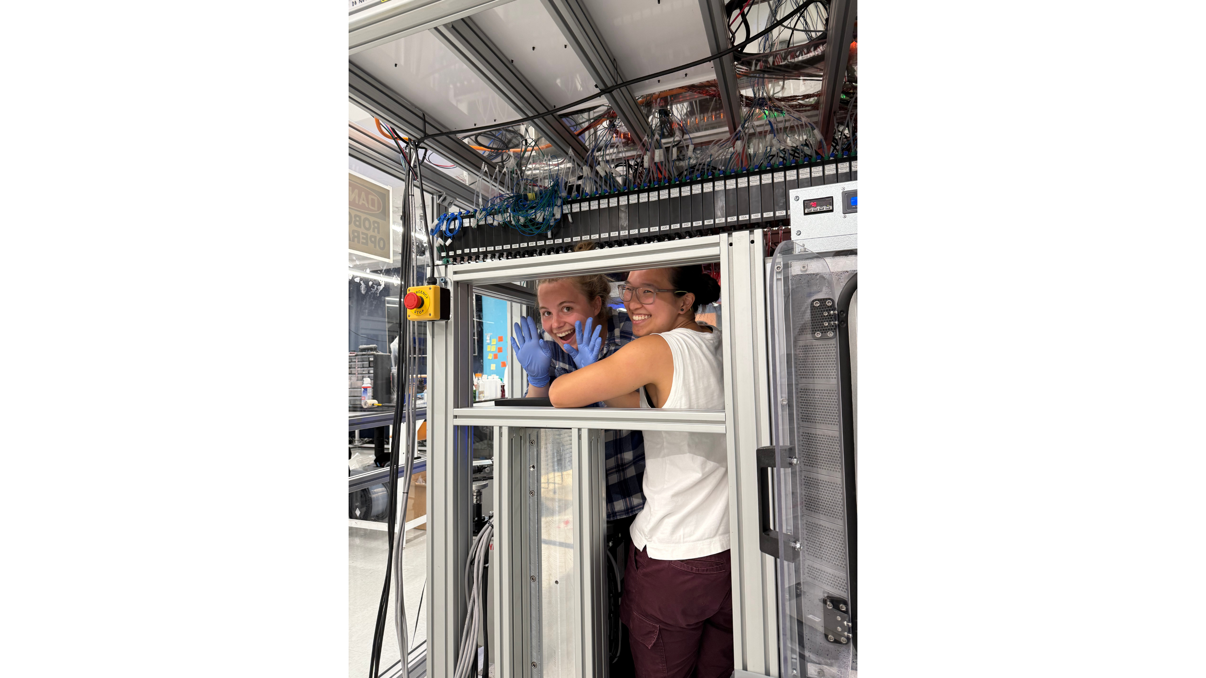 two women in front of a machine