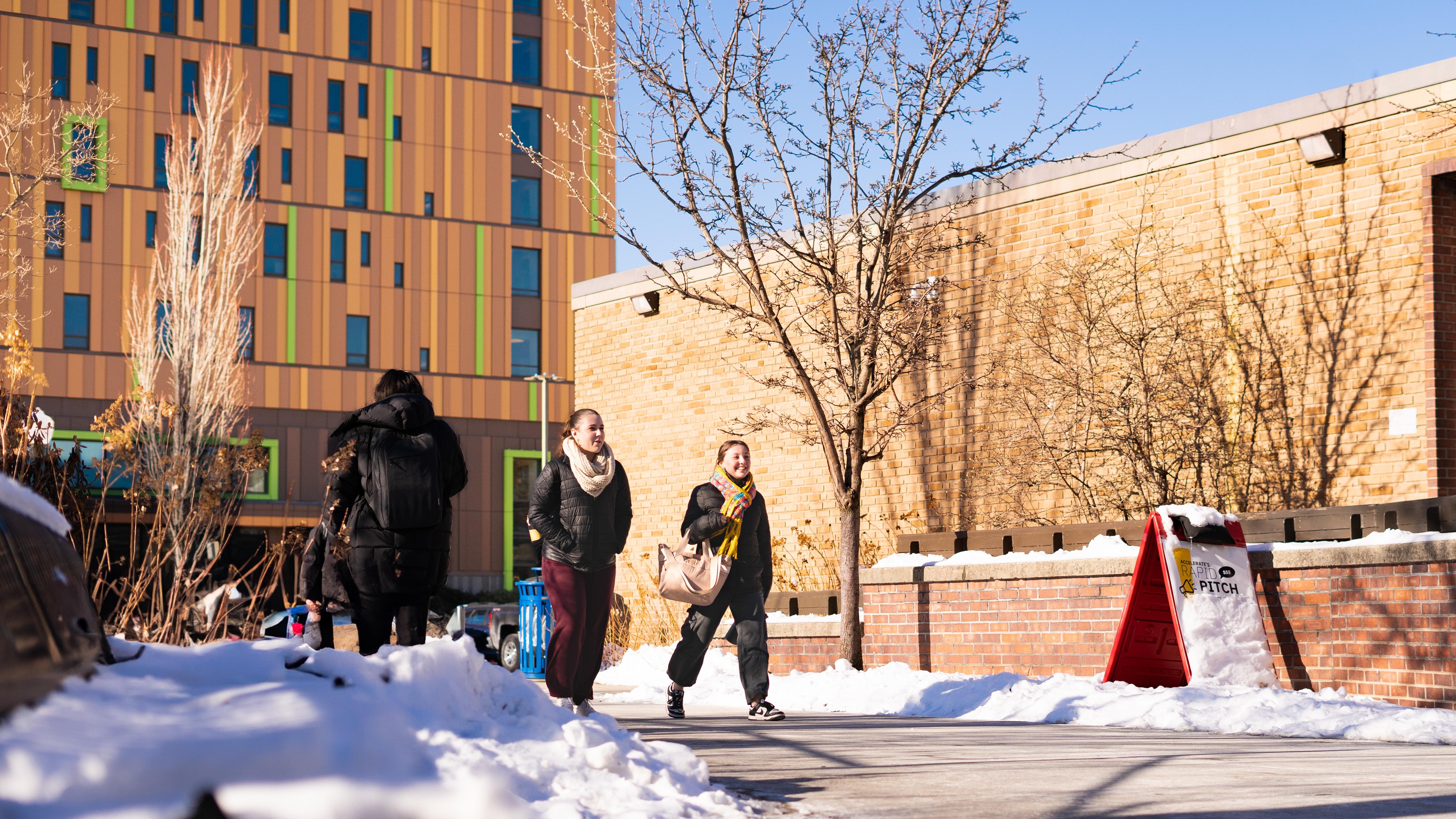 people walking through a snowy walkway