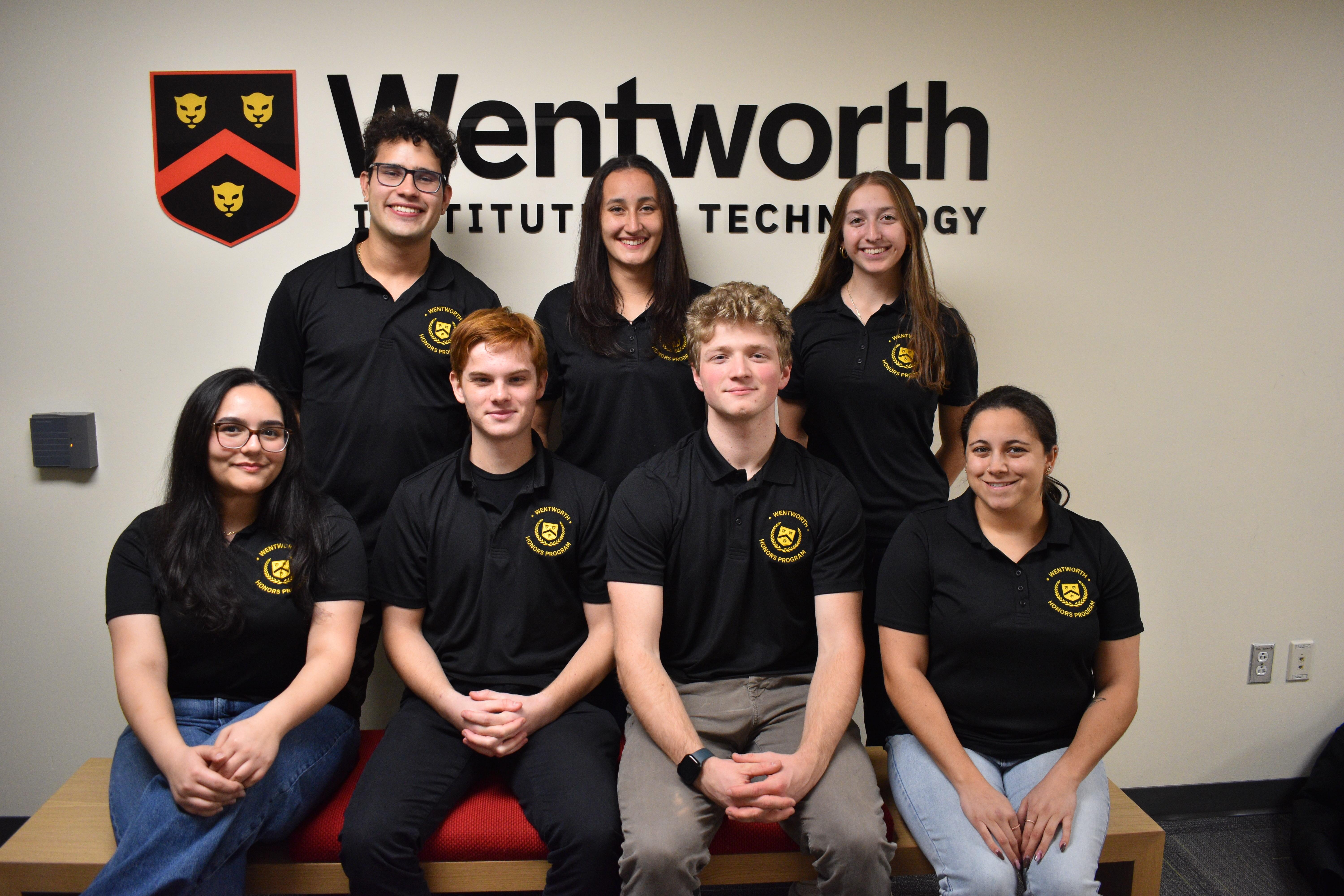 photo of members of the Honors Program Executive Board; four students in front and three in back row; all wearing Honors Program black polos