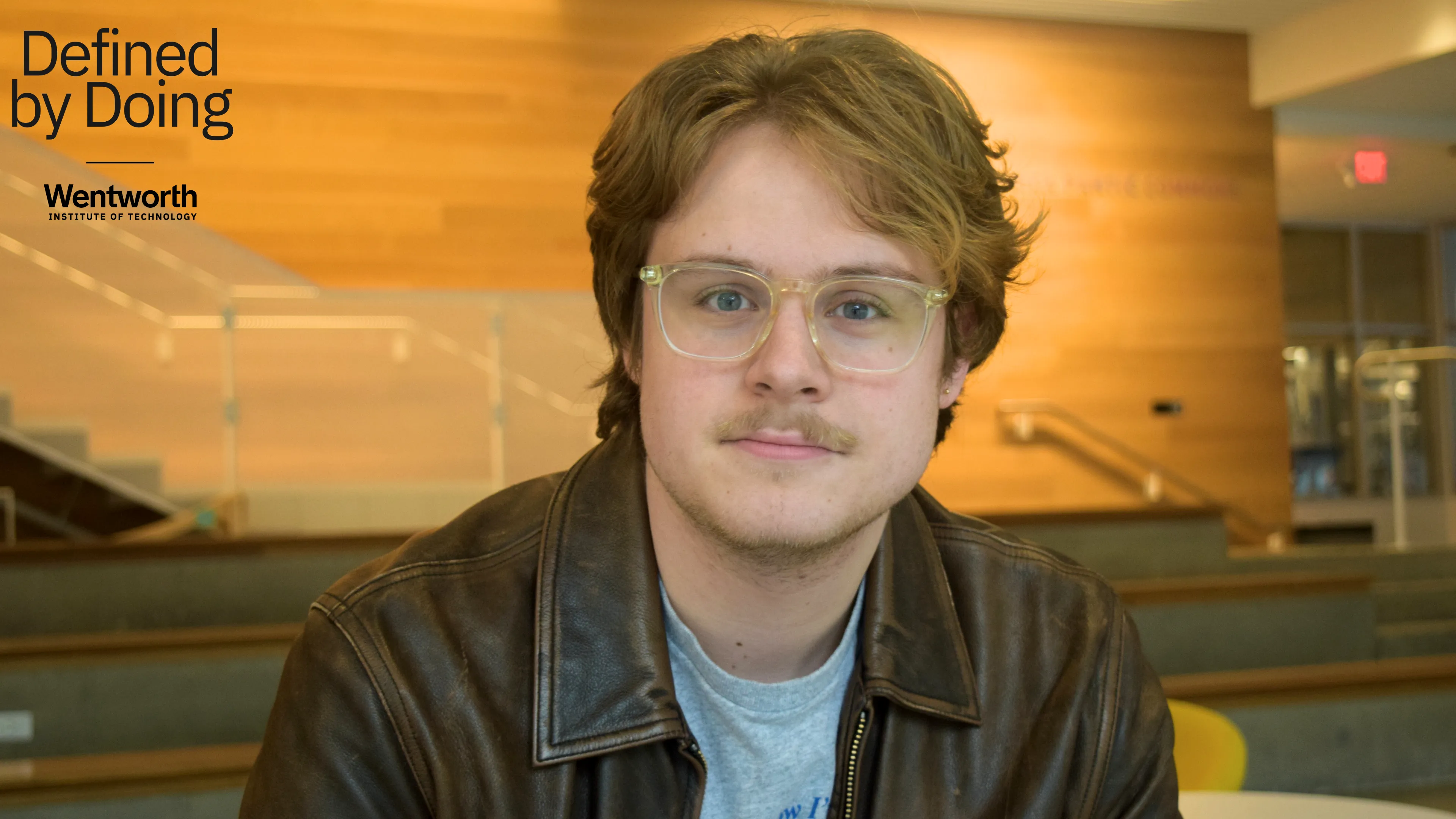 portrait of a man wearing glasses and a leather jacket