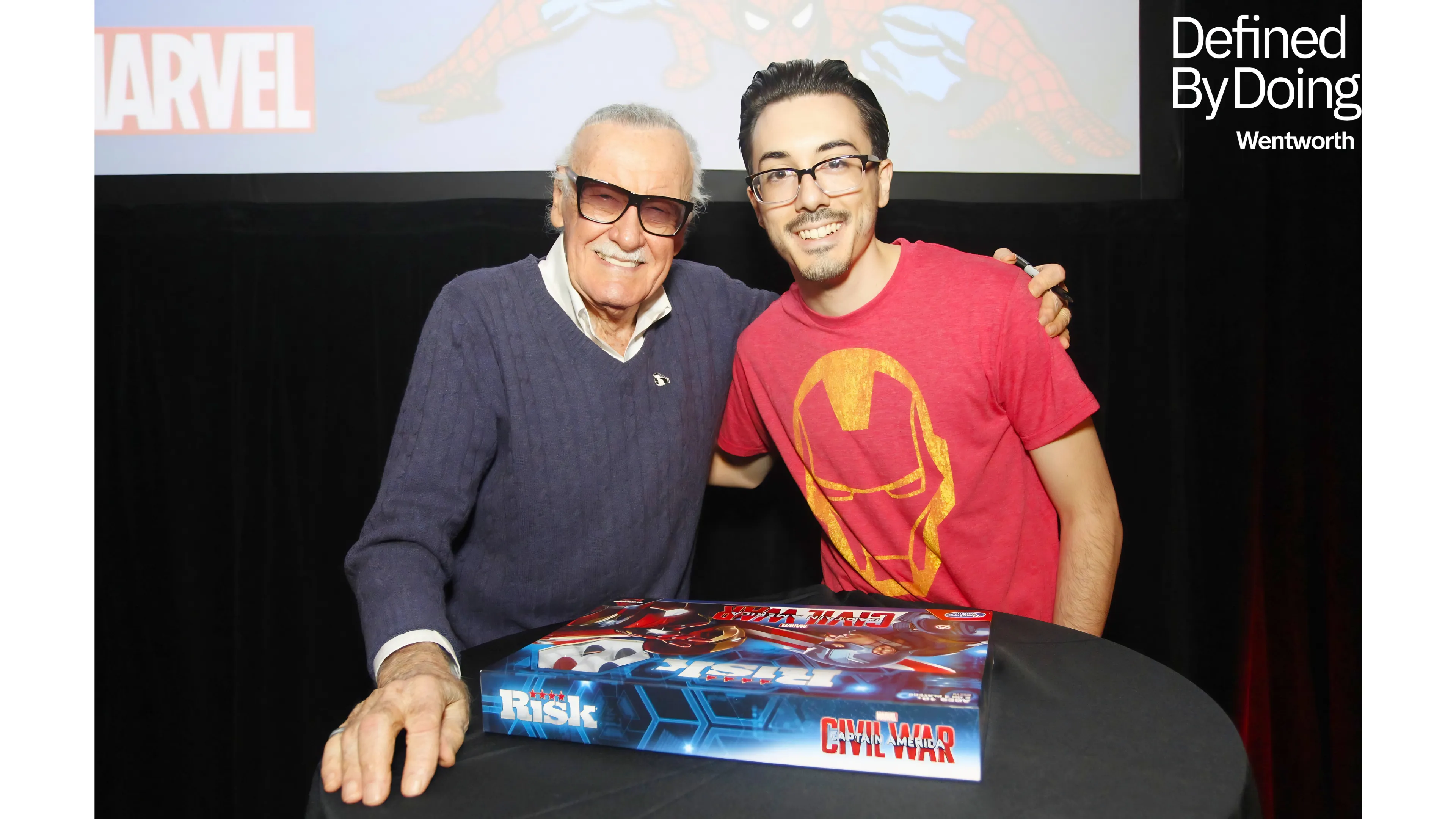 two men pose with a board game