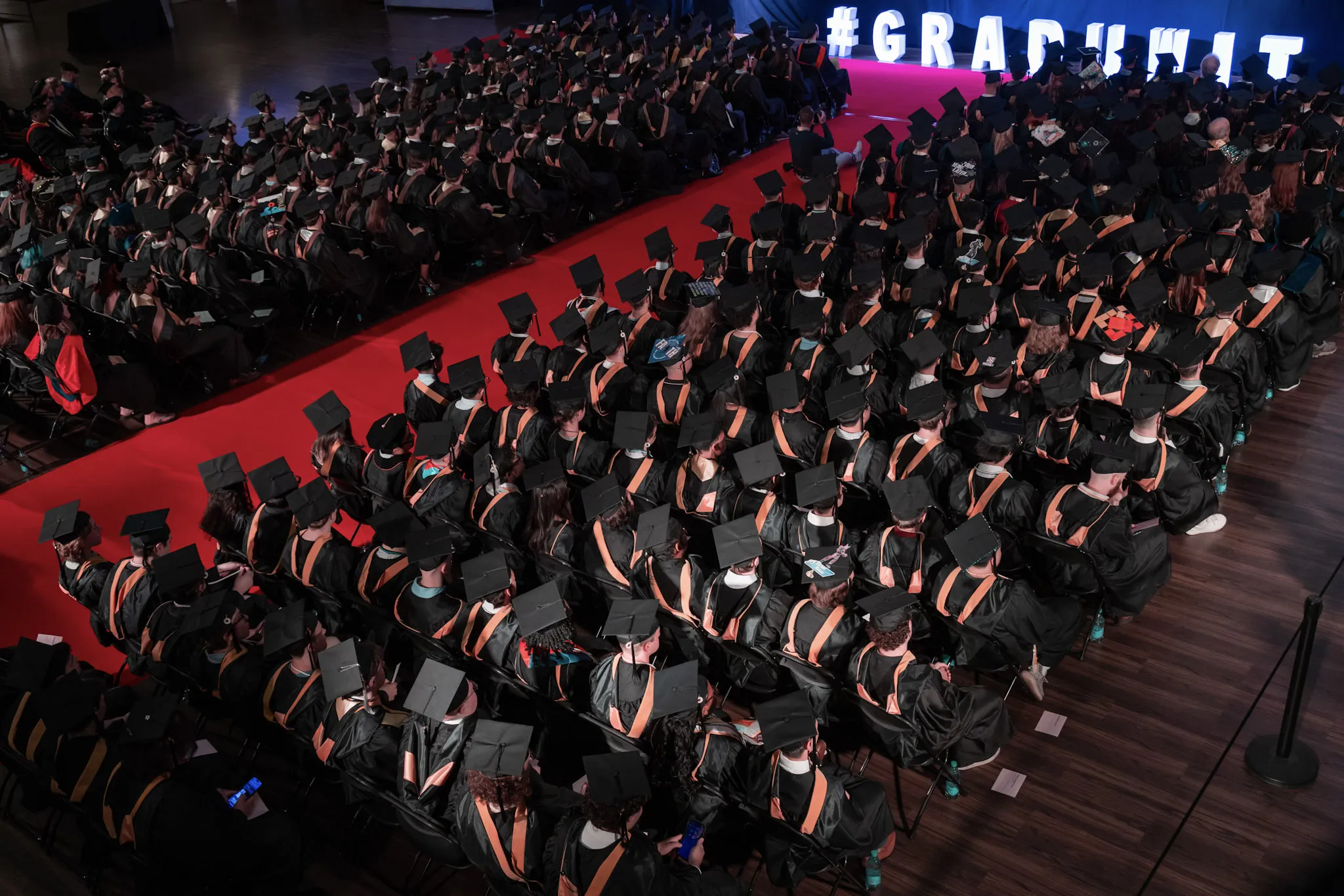 rows of students wearing graduation caps
