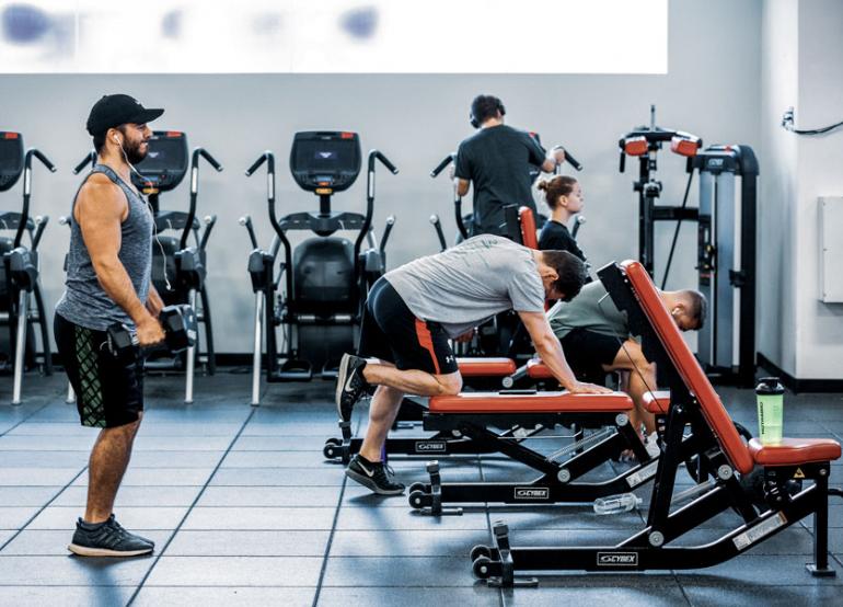 Students lifting weights in the Beatty Hall gym.