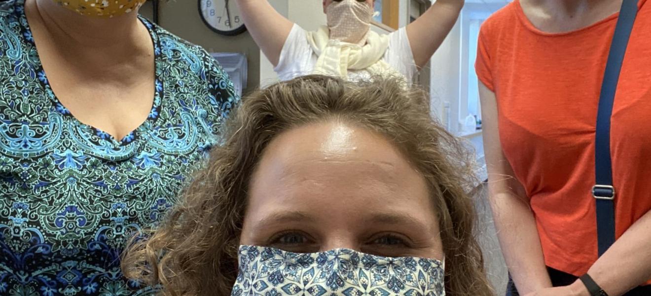 four women wearing protective face masks