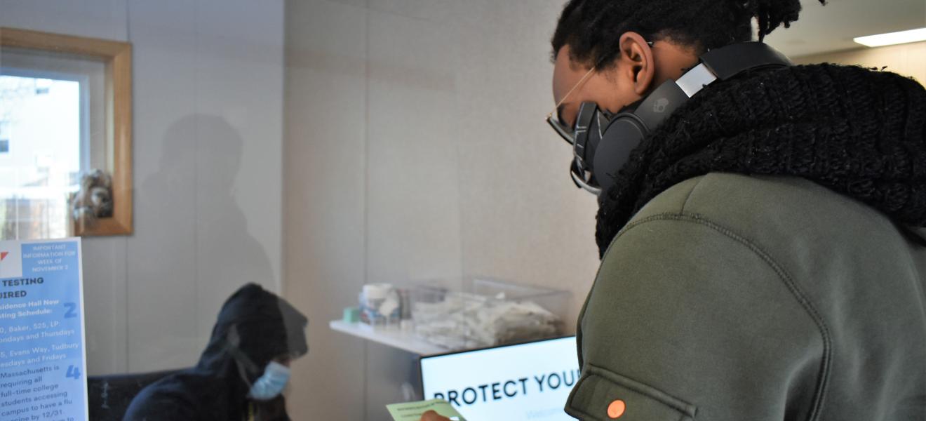 man wearing mask at a check-in table