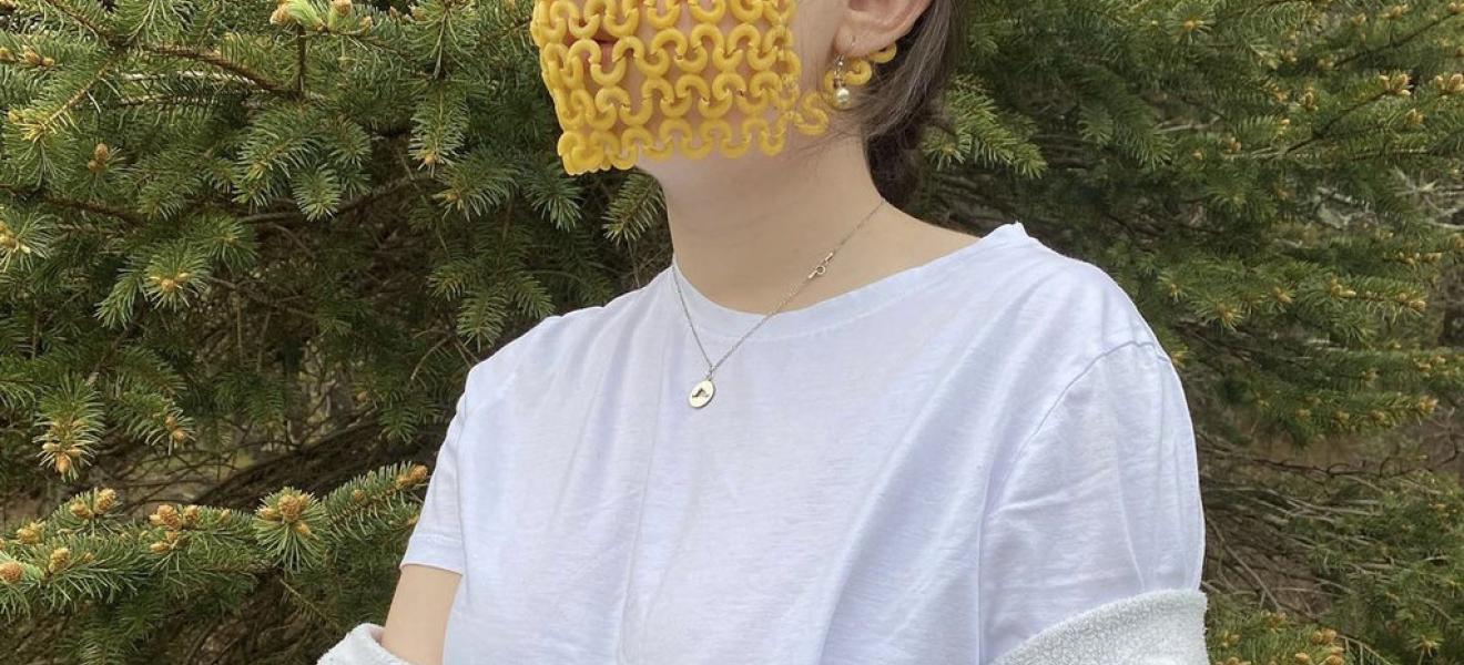 woman wears mask made of pasta