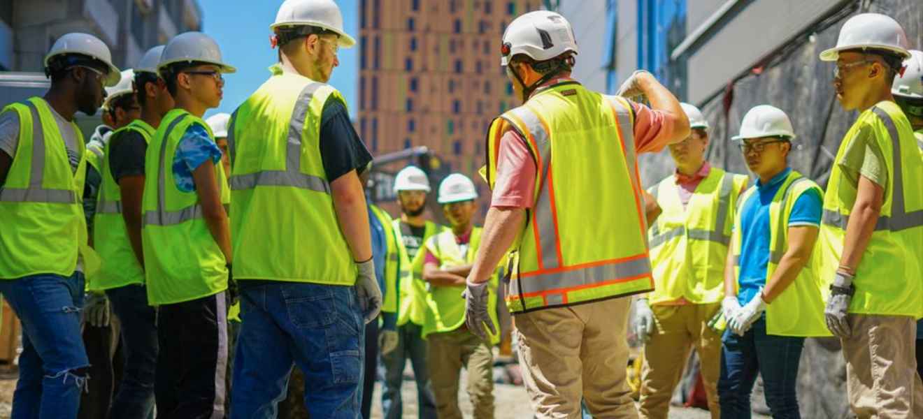 group of workers wearing construction hats and vests