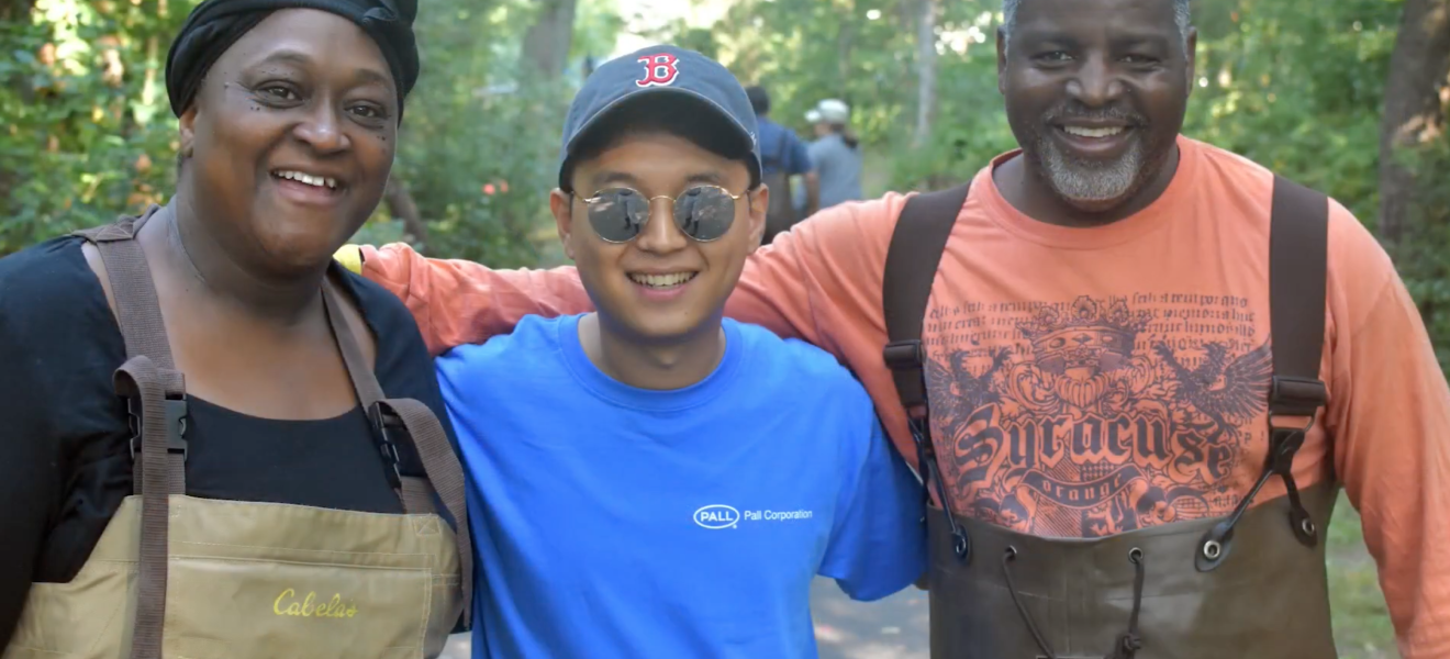 three people posing for camera