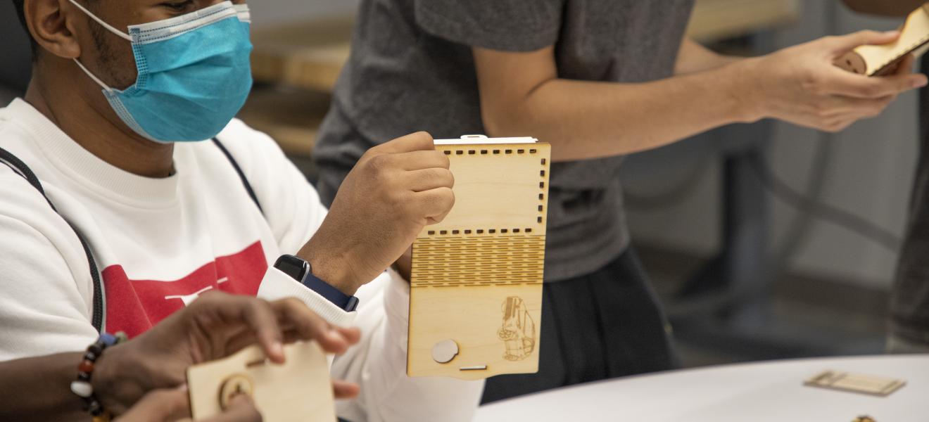 man works on wooden model