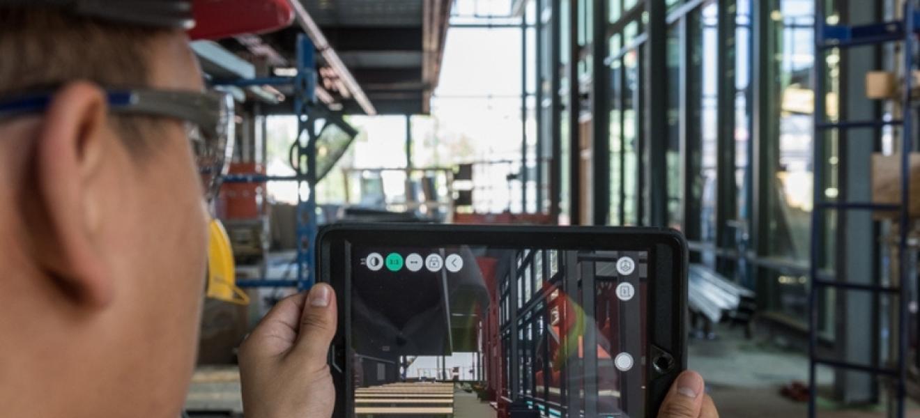 person wearing hard hat examines construction site