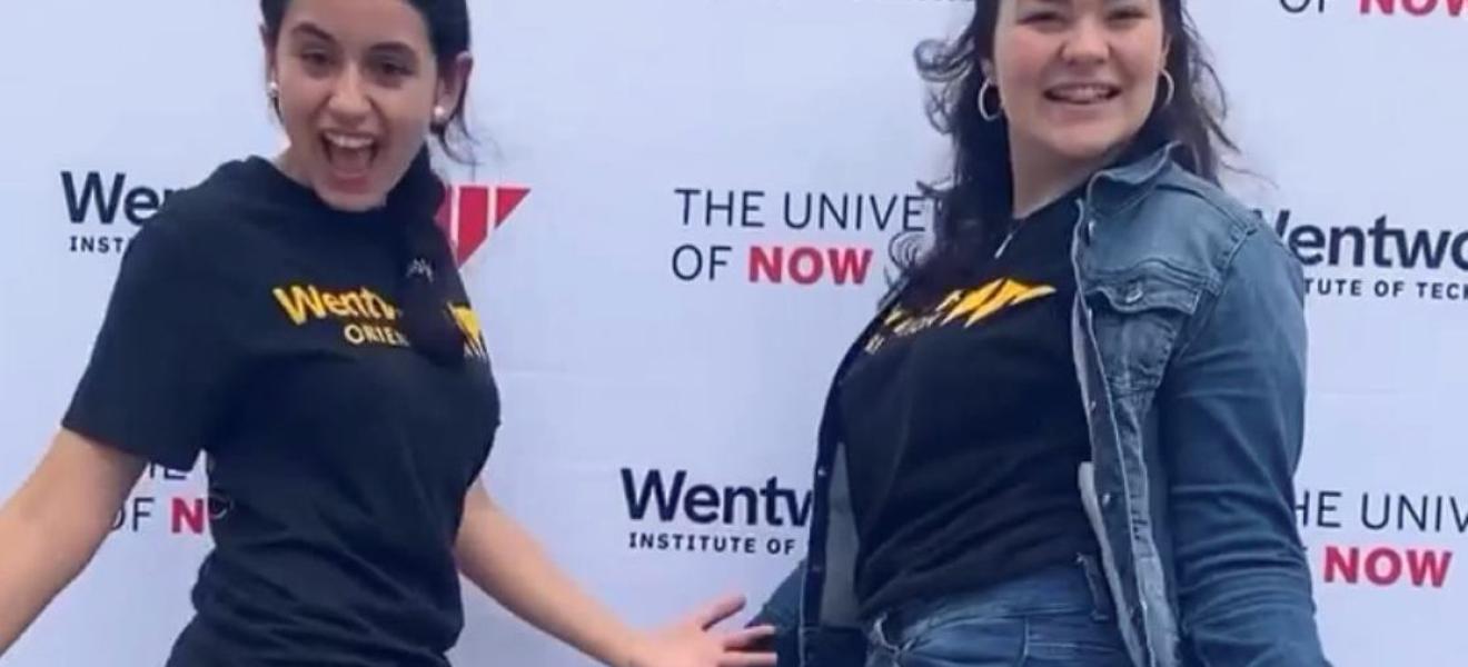 students facing camera and posing with hands out