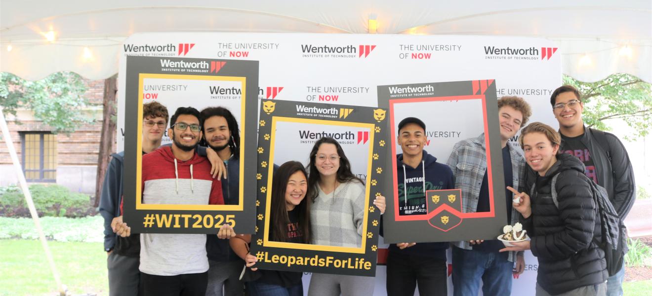 students posing with signs