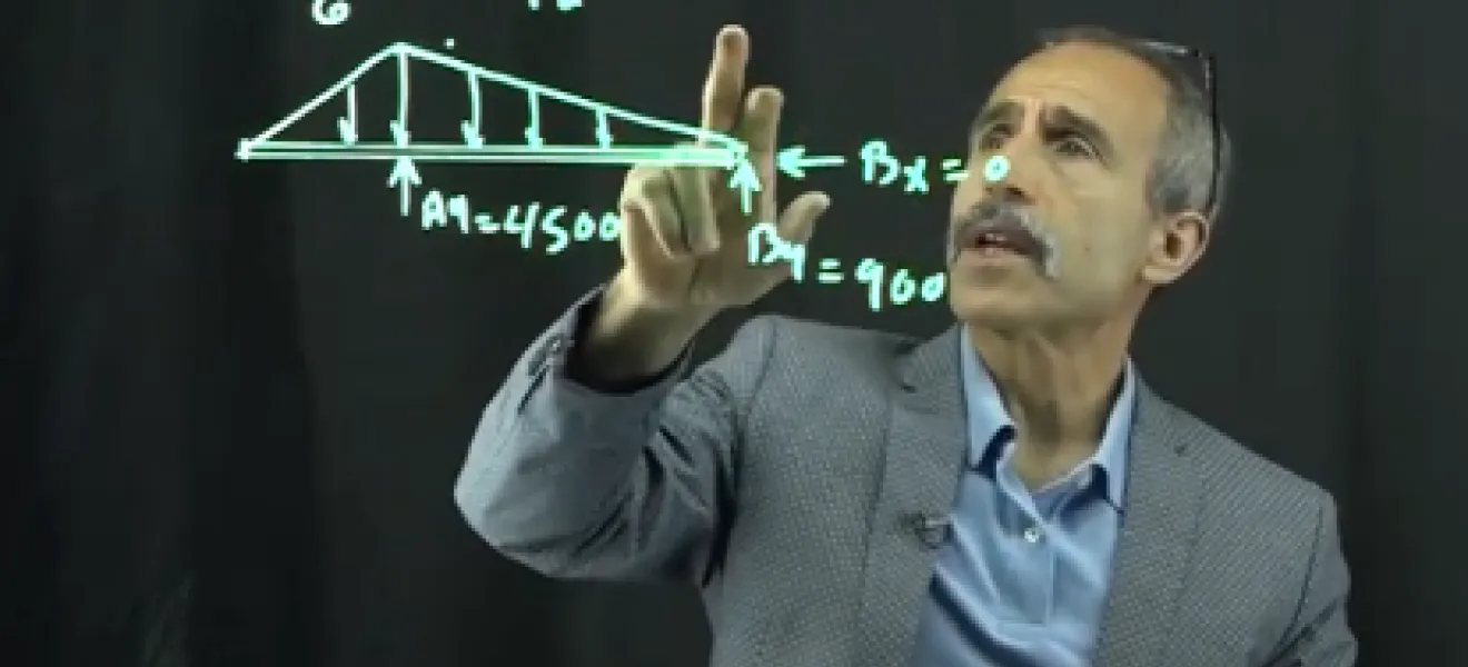 man writing at a lightboard
