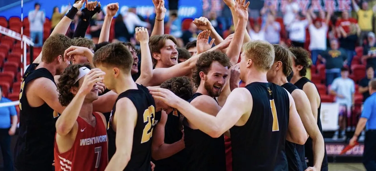group of volleyball players celebrating on the court