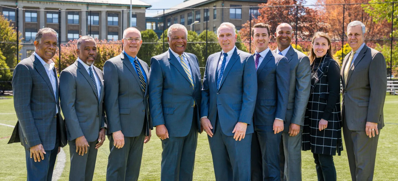 group of people posed on an athletic field