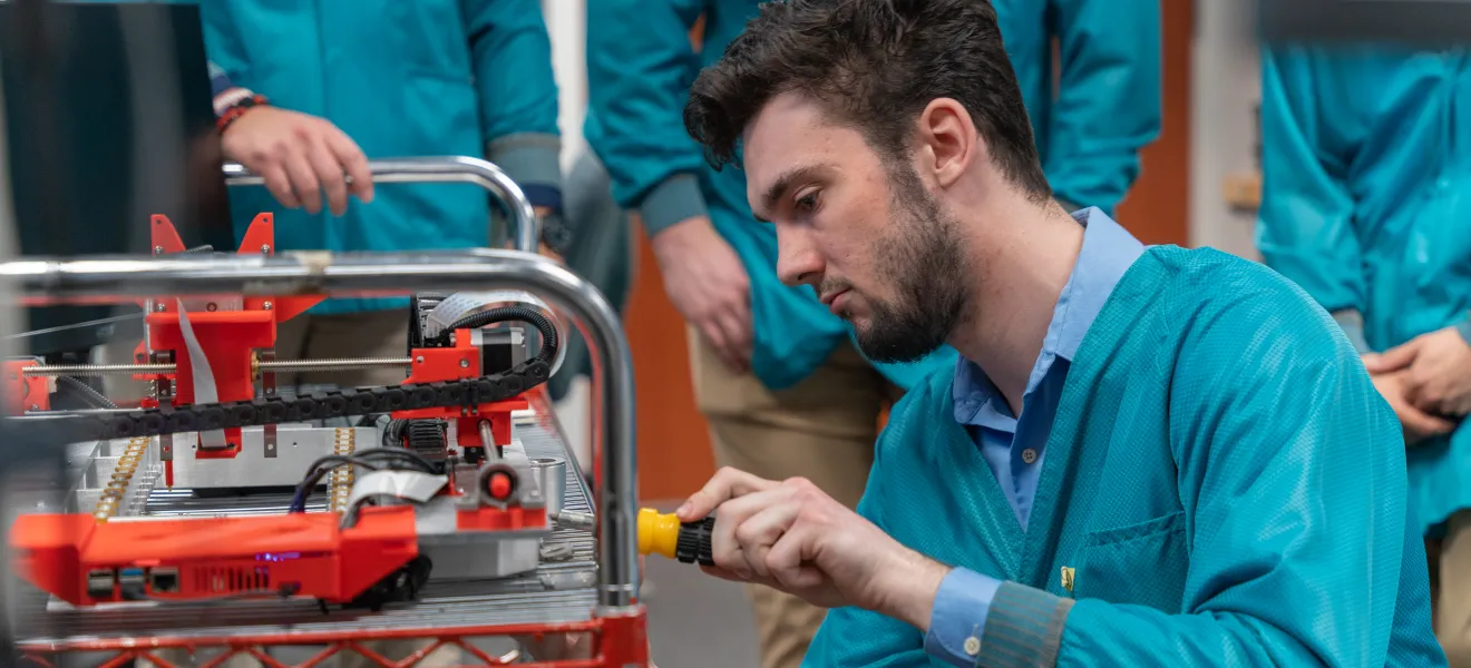 person in a lab working on a computer chip
