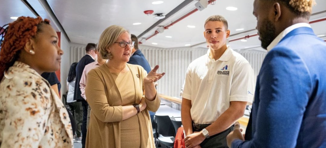 woman talks with students