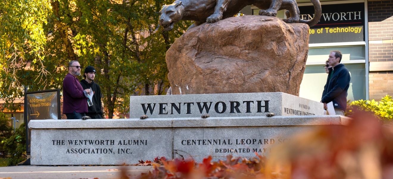 orange leaves in from of a leopard statue