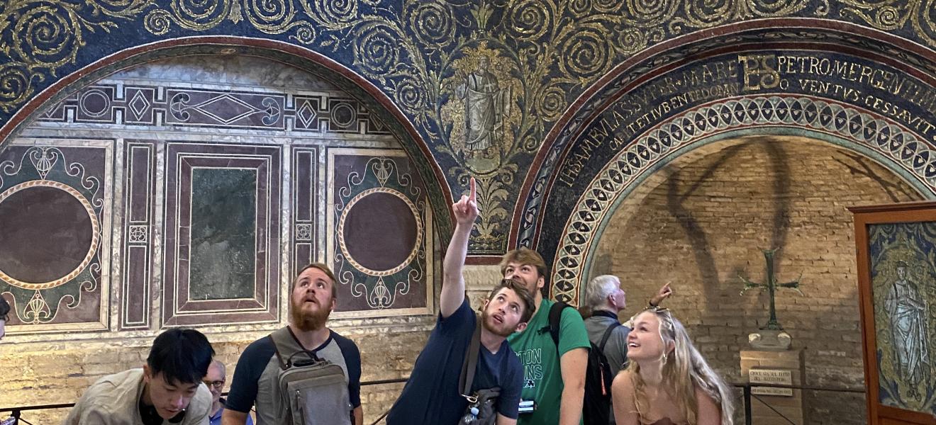 students in a historic building point to various items