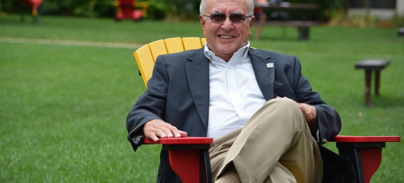 man sitting in a chair outside