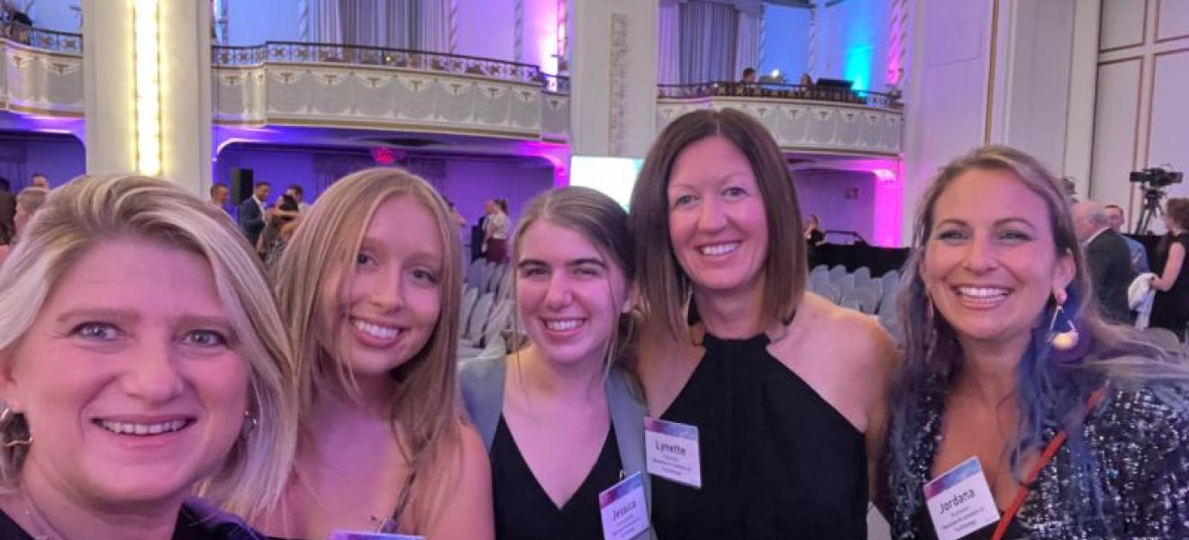 five woman attending an awards ceremony