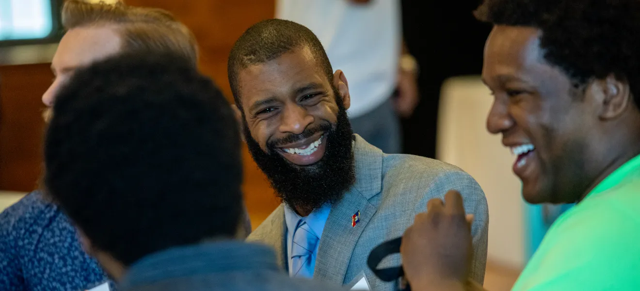 two men share a laugh during a lunch event