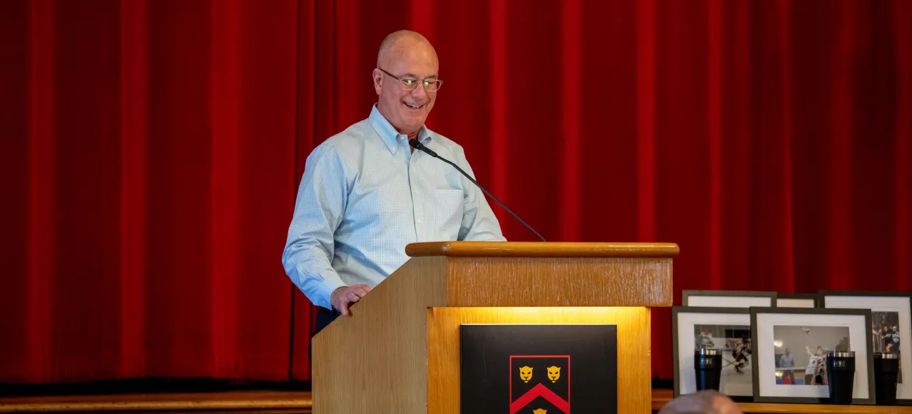 a man speaking at a podium