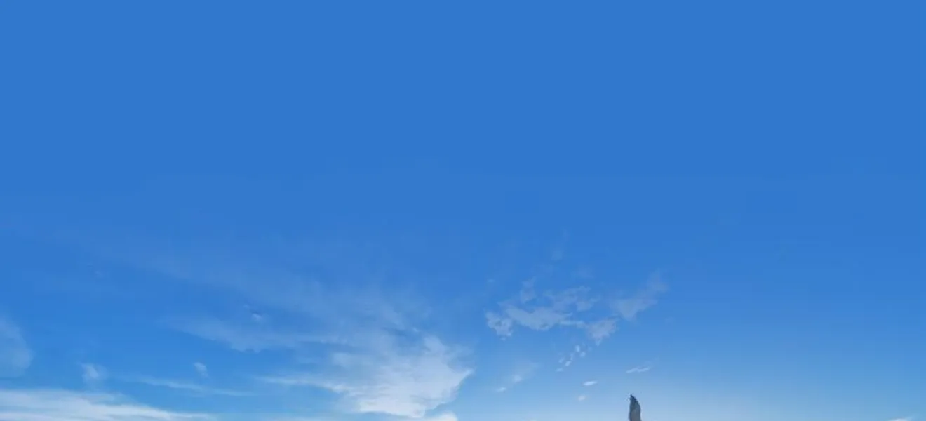 a beach with waves and blue sky