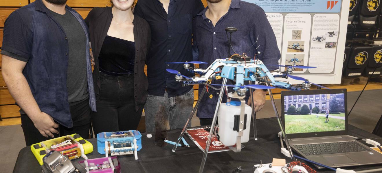 students standing with a robotic drone