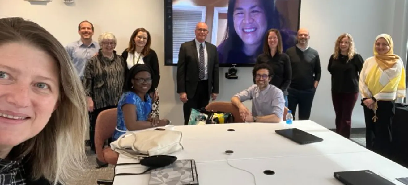 group of people at a table looking at the camera