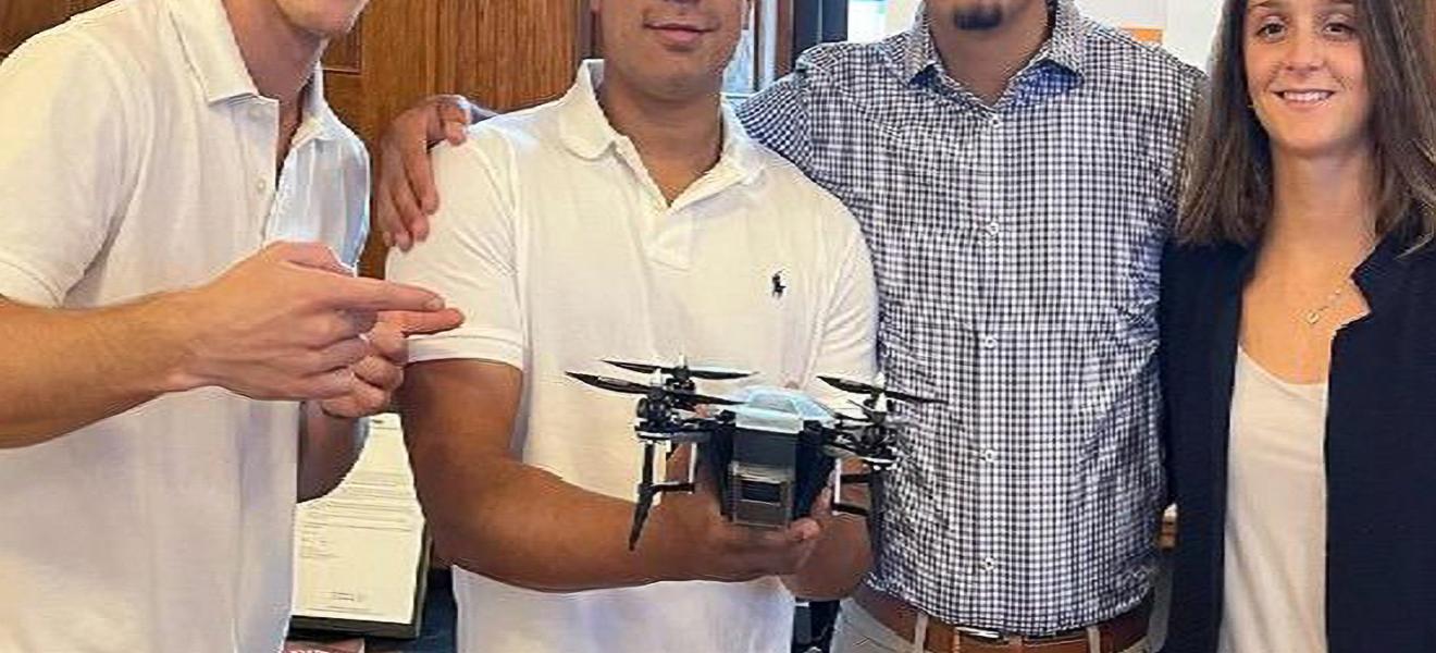 students holding up a drone prototype