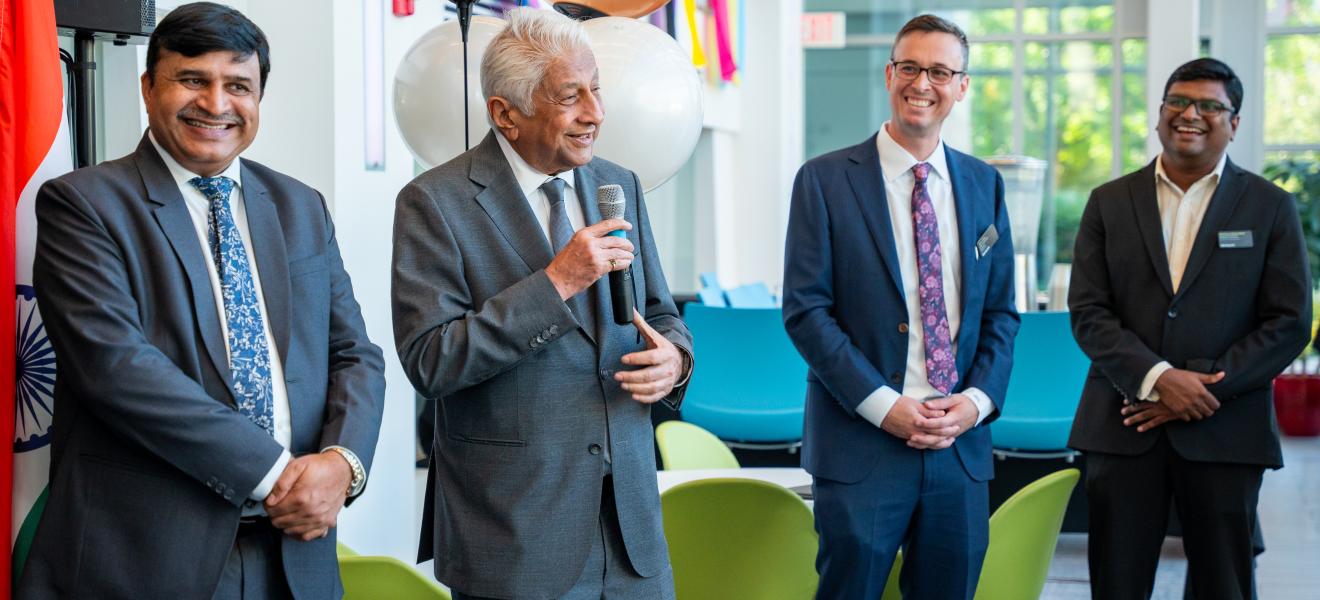 people speaking at an event while standing in a line