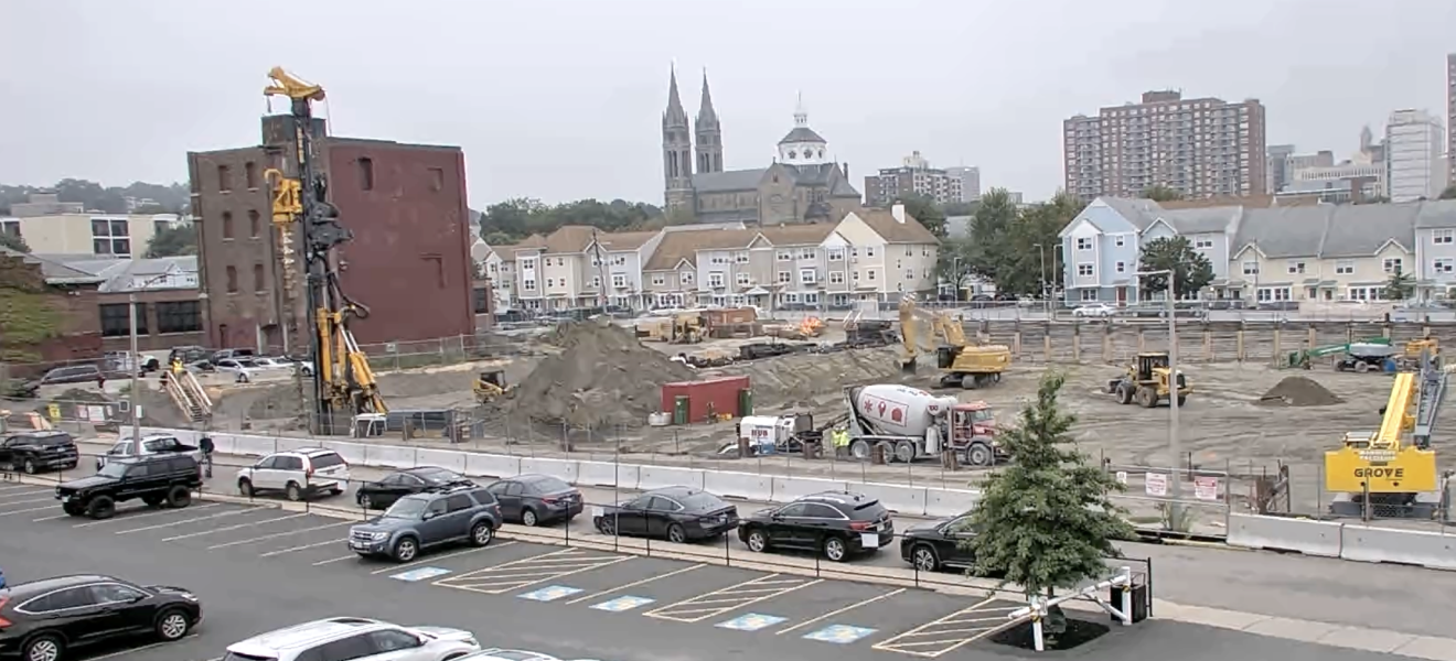 construction site showing an excavator and other equipment