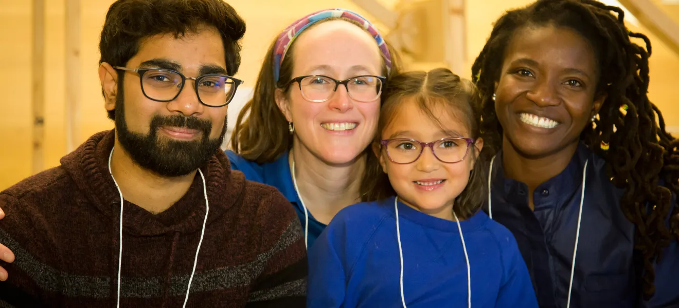 portrait of four people smiling at the camera