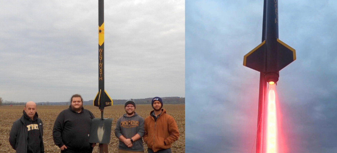 group of people stand with a rocket they built