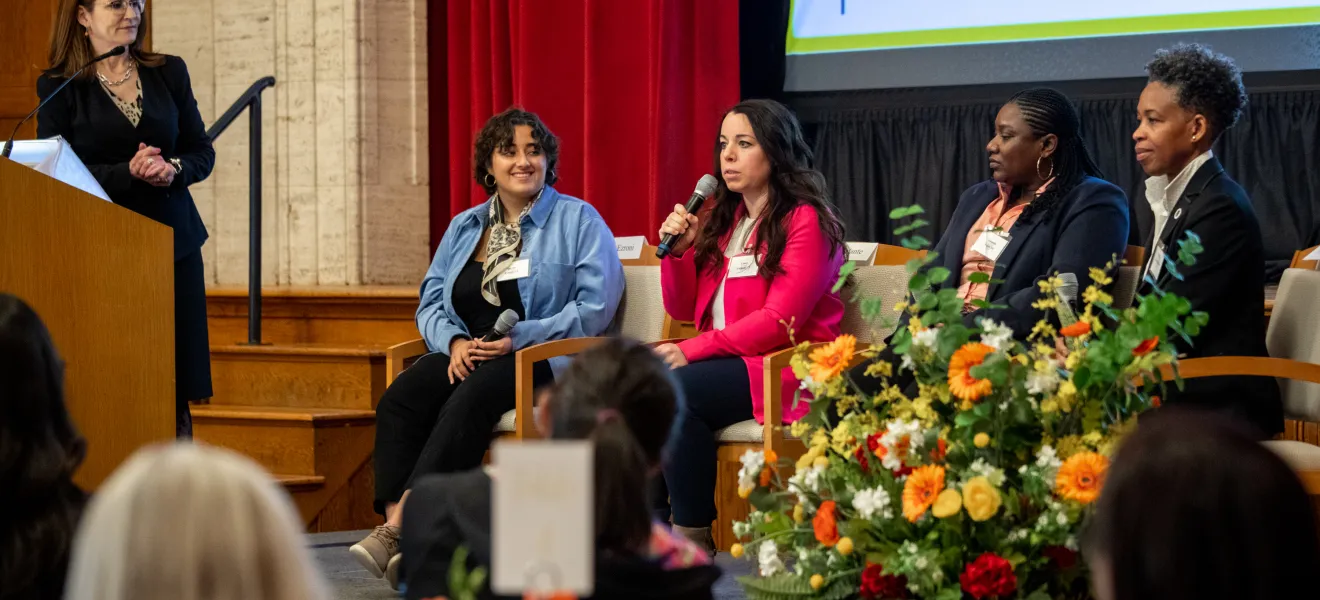 women speaking as part of a panel group