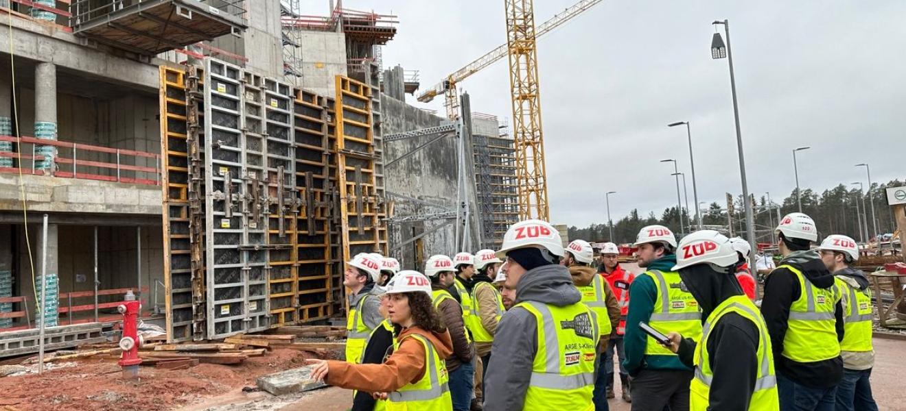 group of students in hard hats touring an air force base