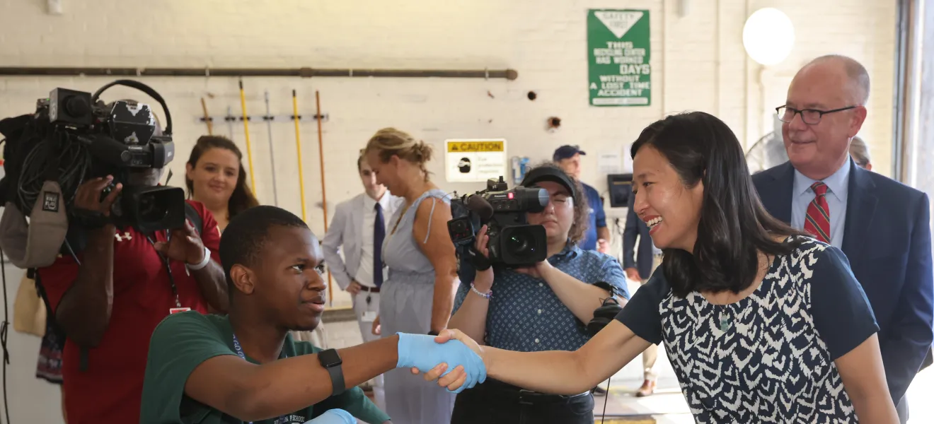 people shaking hands in a recycling facility