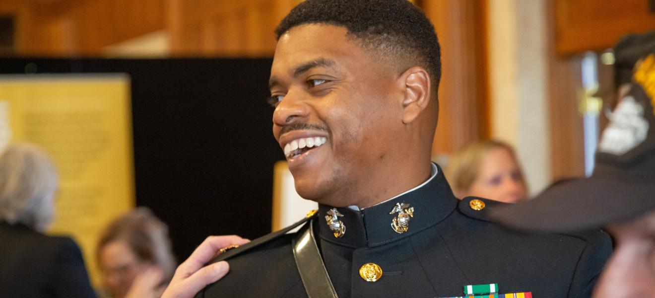 a man in military uniform smiles