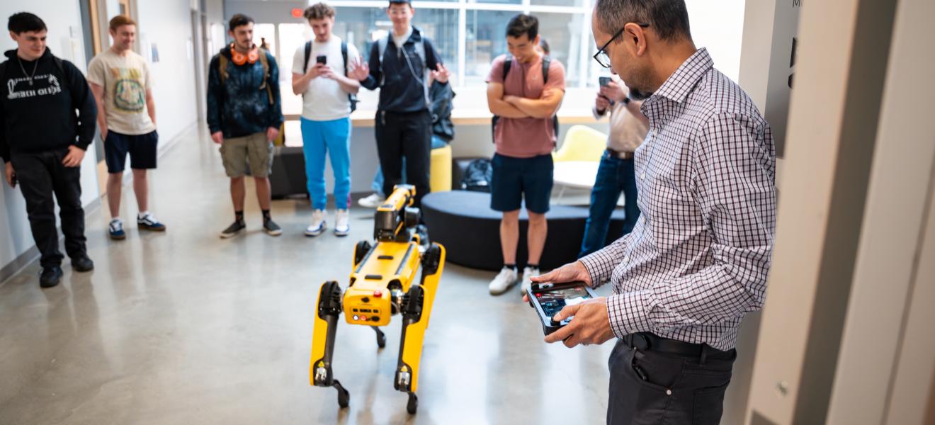 people operating a robotic dog