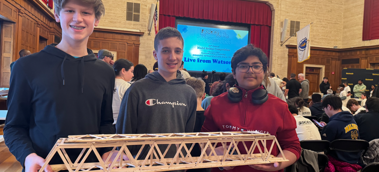 kids holding up a model bridge