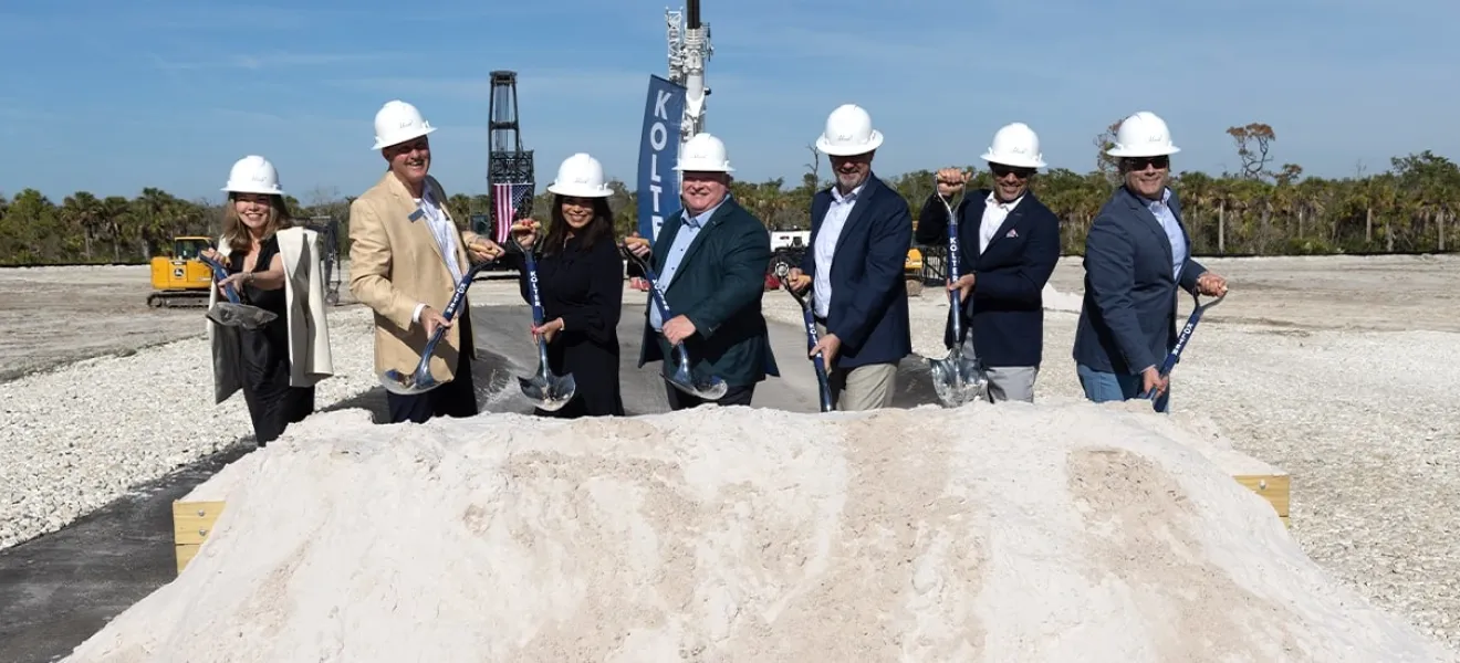 people in hard hats and holding shovels at a ceremony
