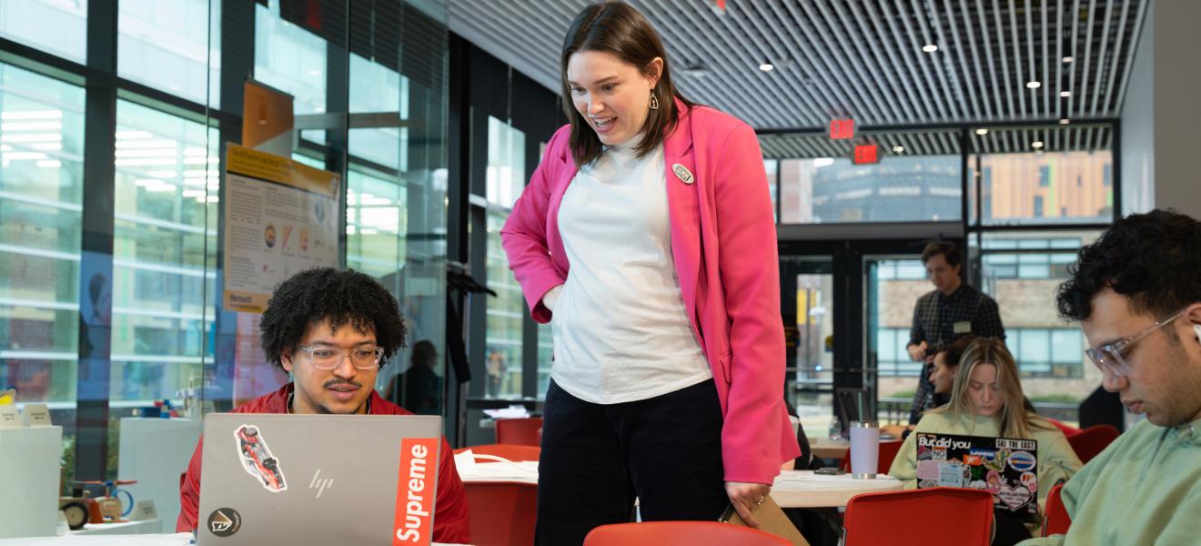 a professor works with people on how to edit website pages