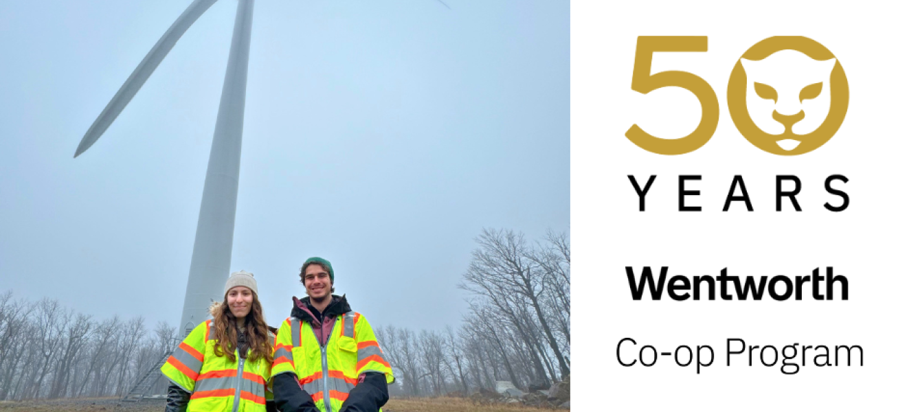 two students in front of a wind turbine