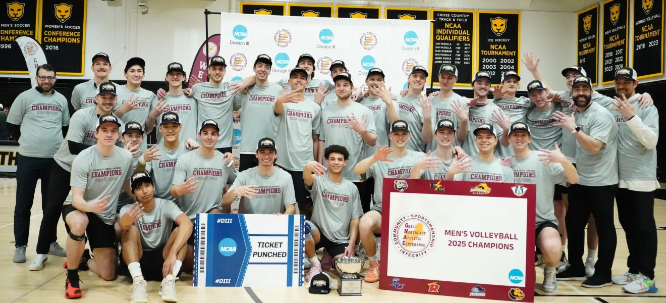 a group of volleyball players posing for a photo
