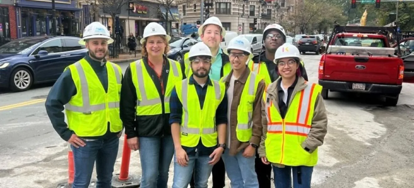 a group of people in the city wearing hard hats