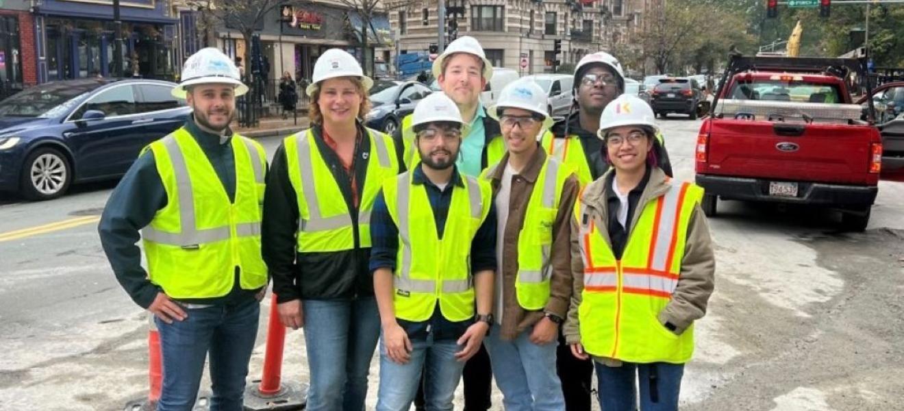 a group of people in the city wearing hard hats