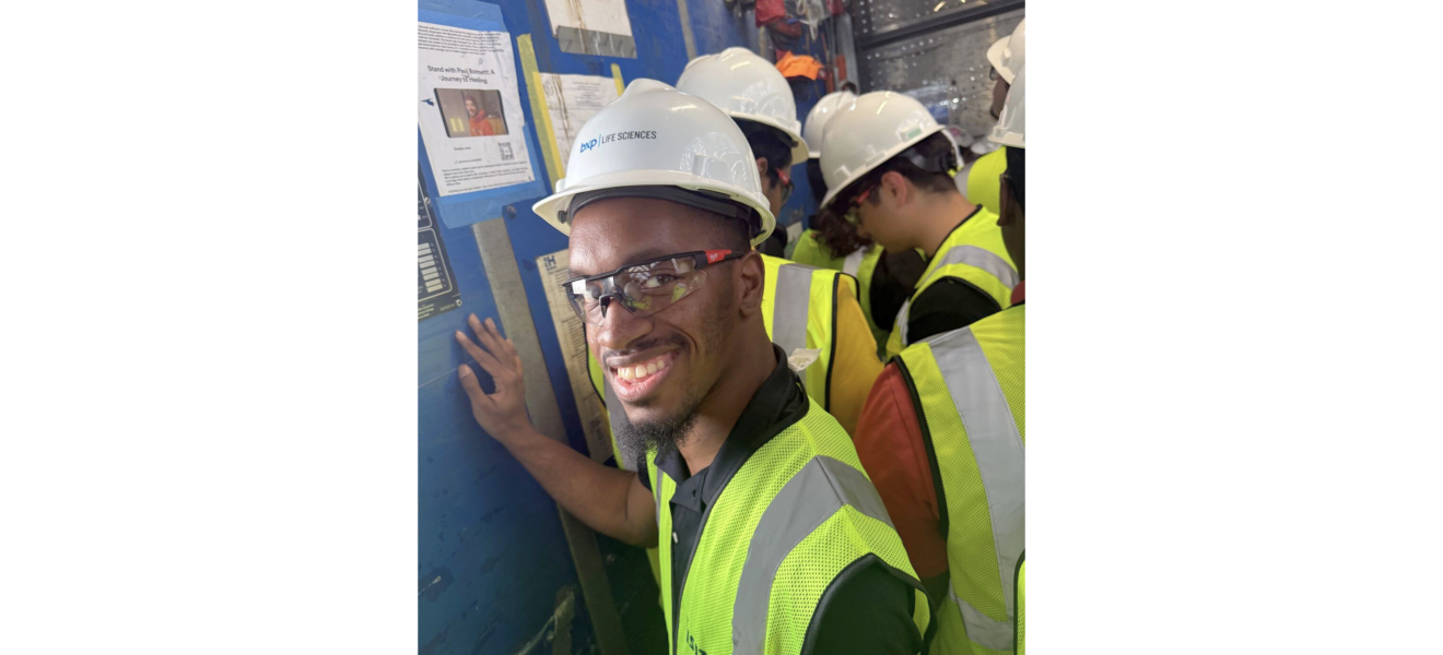 people in hard hats on a company tour