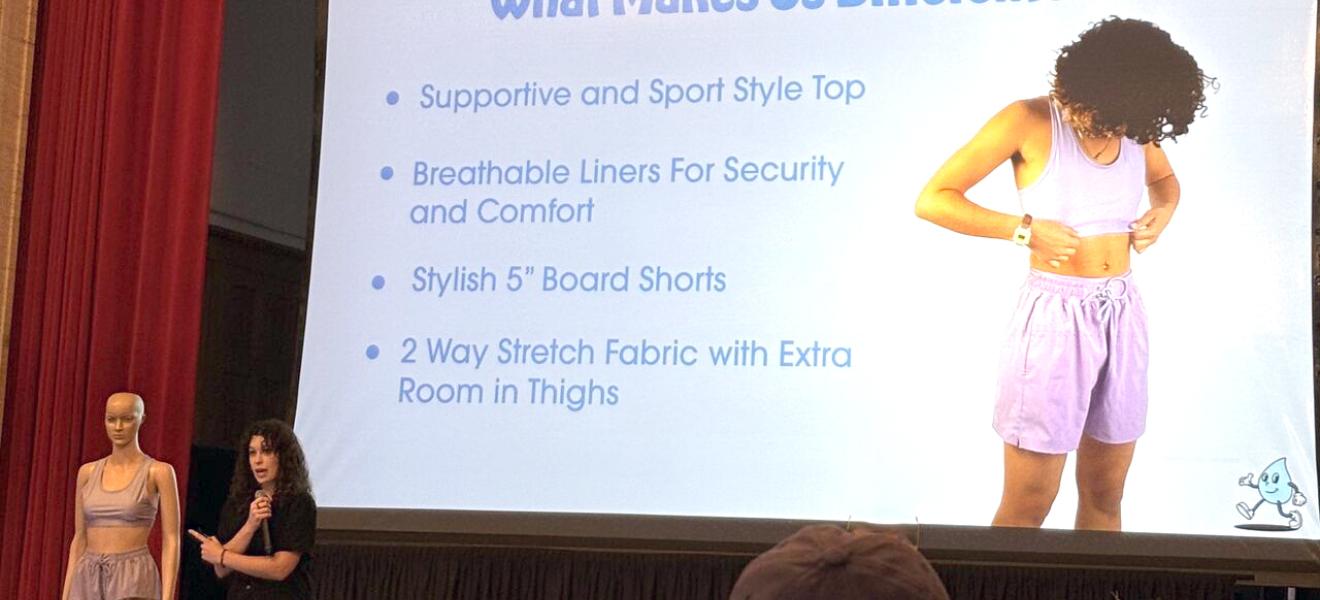 a woman presents swimwear designs to an audience